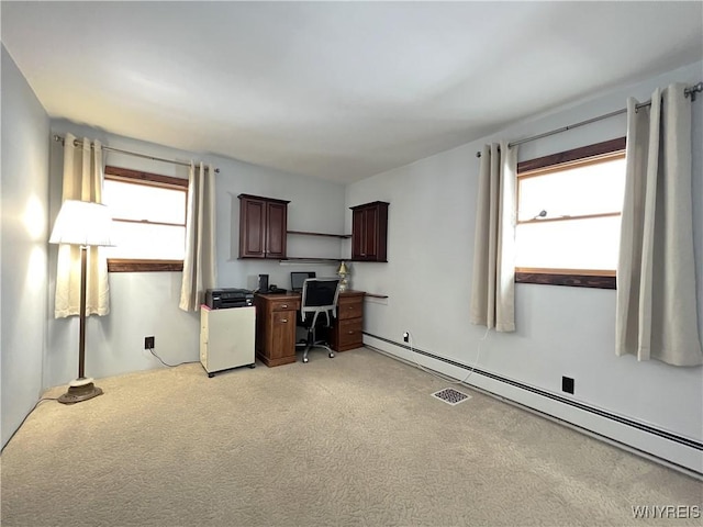 unfurnished office with a baseboard radiator and light colored carpet