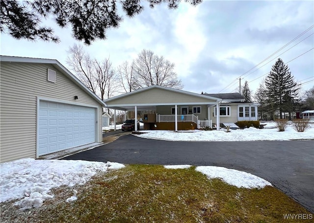 view of front of property with a garage, driveway, and a porch