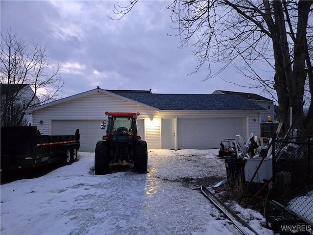 single story home with a garage and a shingled roof