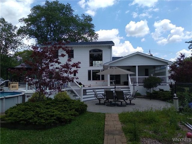 back of house with a patio area and an outdoor pool