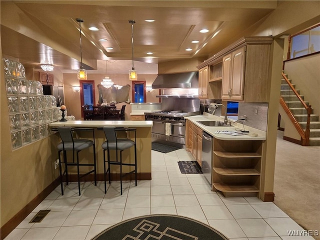 kitchen featuring wall chimney exhaust hood, appliances with stainless steel finishes, a peninsula, open shelves, and a sink