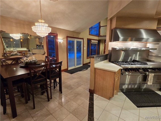 kitchen with light tile patterned floors, tasteful backsplash, baseboards, vaulted ceiling, and a notable chandelier