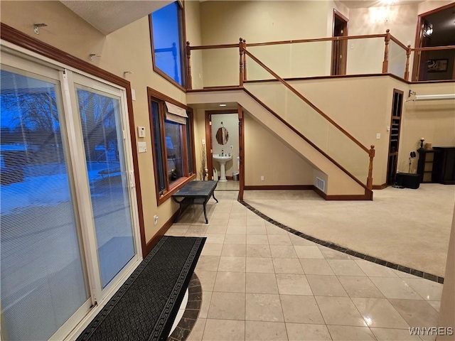 interior space featuring stairs, a sink, and visible vents