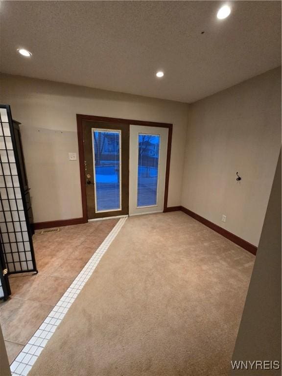 interior space with light tile patterned floors, recessed lighting, light colored carpet, and baseboards