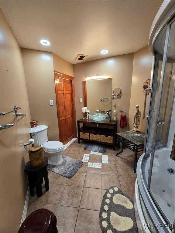 bathroom with toilet, recessed lighting, vanity, tile patterned floors, and an enclosed shower