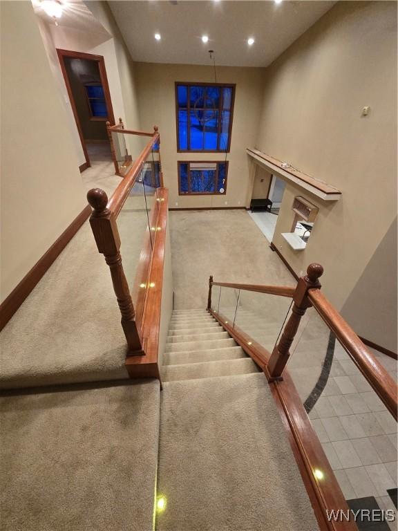 stairs with carpet, baseboards, and recessed lighting