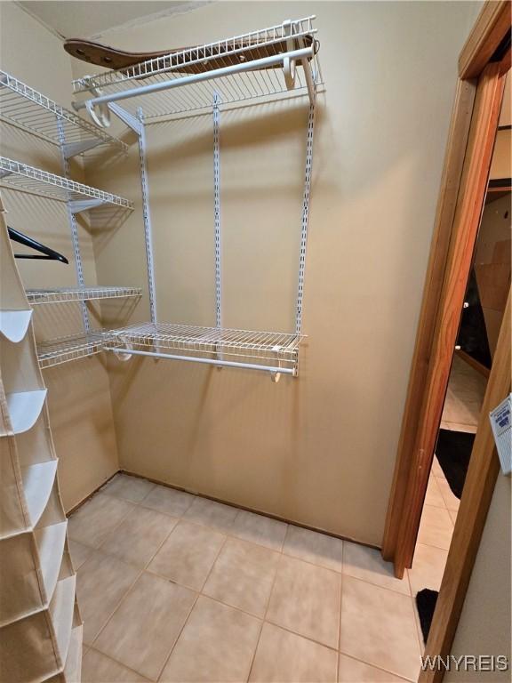 spacious closet featuring light tile patterned floors