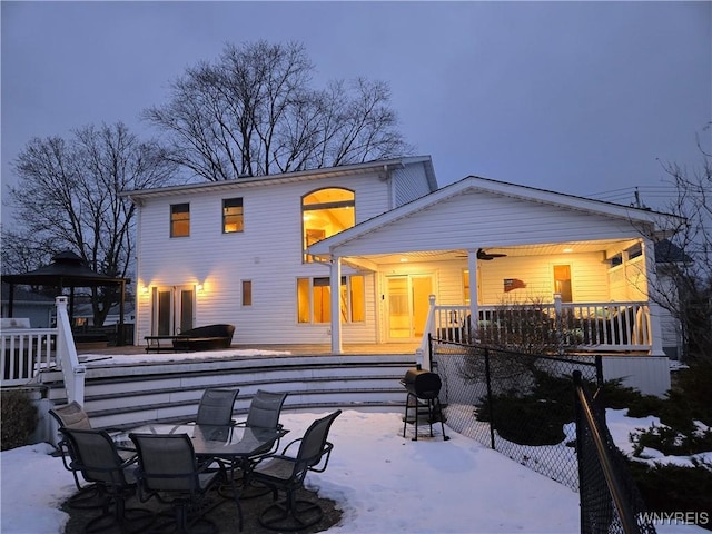 snow covered back of property featuring outdoor dining space