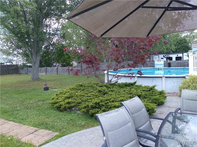 view of yard featuring a fenced backyard, a fenced in pool, and a patio