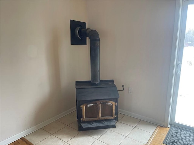 details featuring a wood stove and baseboards