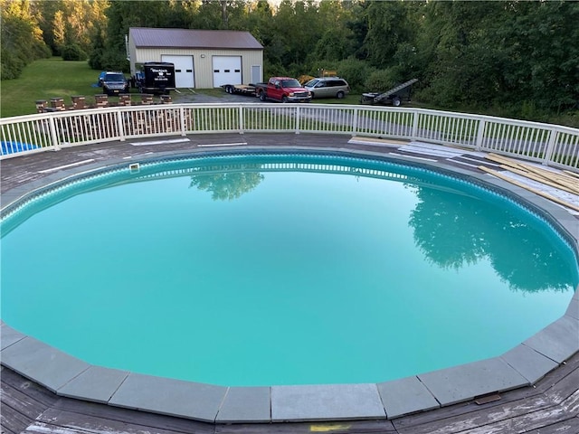 pool with an outbuilding and a wooden deck