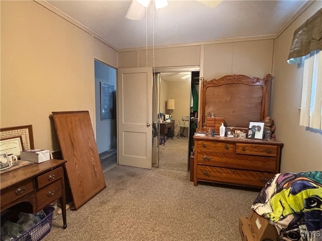 carpeted bedroom featuring crown molding and ceiling fan