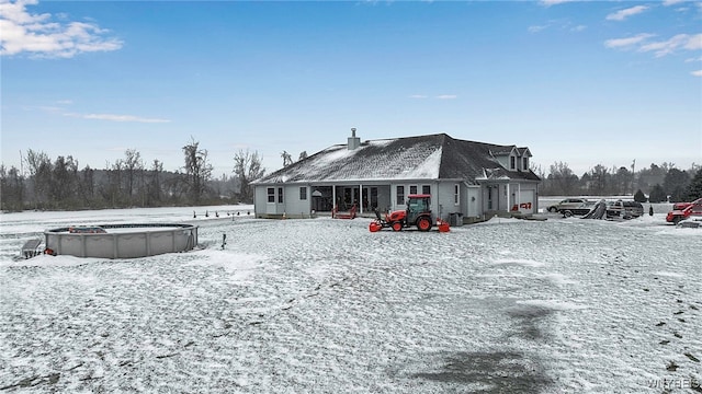 snow covered house featuring an outdoor pool