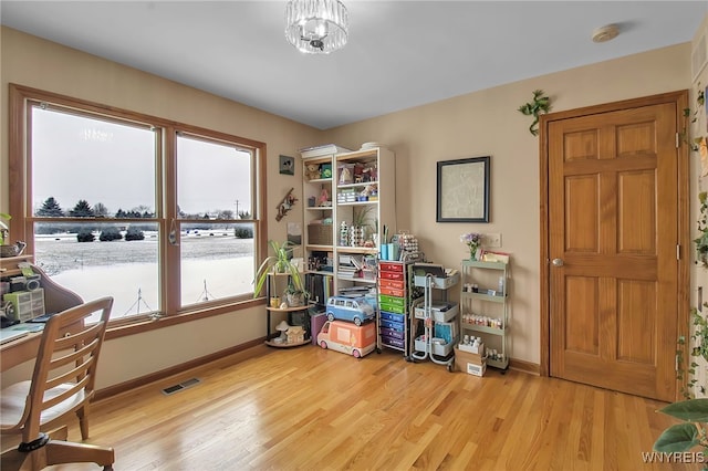 office area featuring light wood-type flooring, baseboards, and visible vents