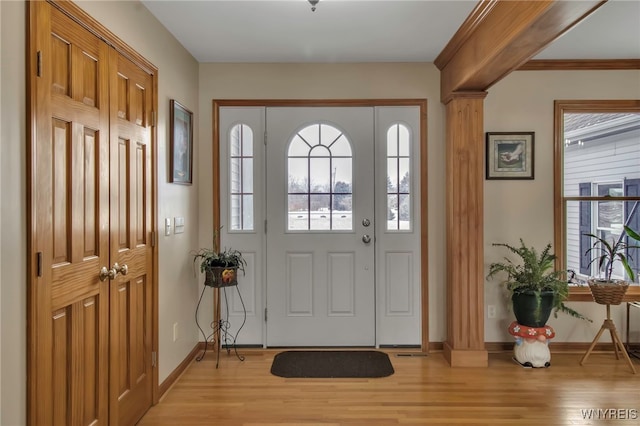 foyer featuring light wood-type flooring and baseboards