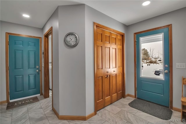 entryway with recessed lighting and baseboards