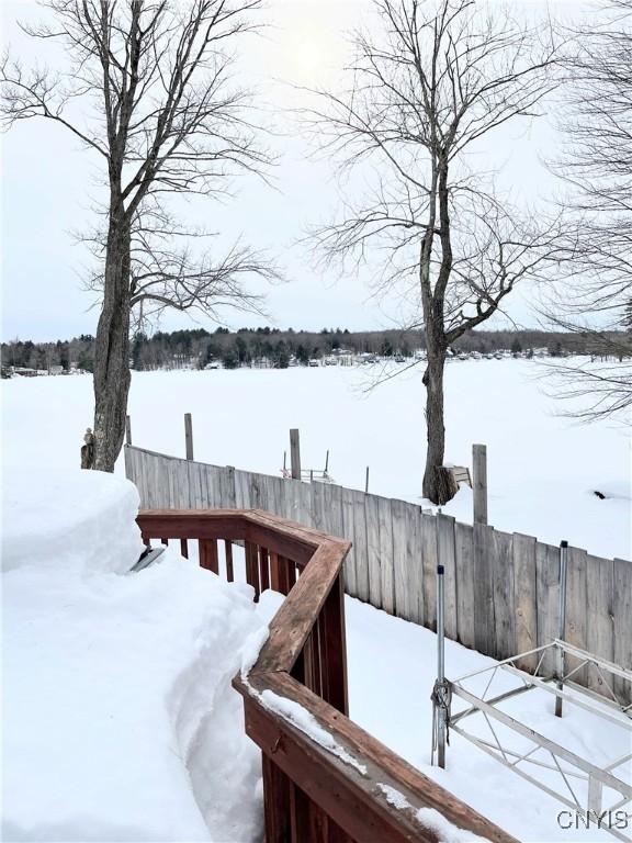 snow covered deck with fence