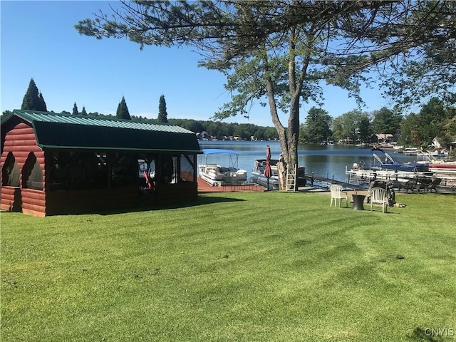 exterior space featuring a water view and a lawn