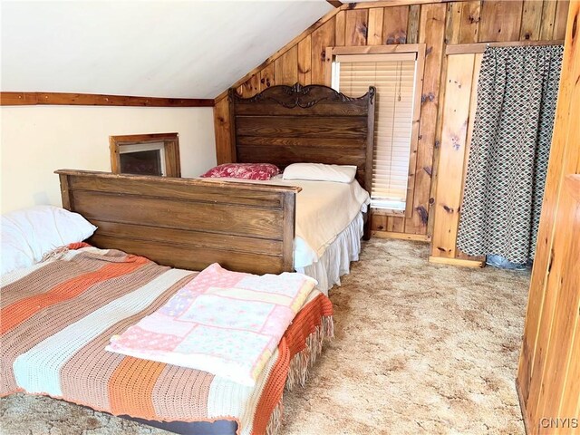 carpeted bedroom featuring wood walls and vaulted ceiling