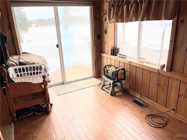 living area with plenty of natural light, wood finished floors, and visible vents