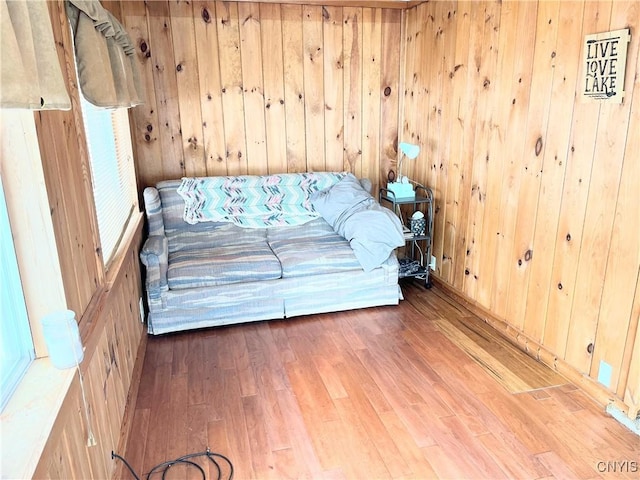 unfurnished room featuring wooden walls and wood finished floors