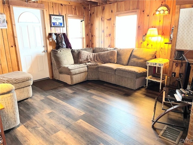 living room with wood finished floors and wooden walls