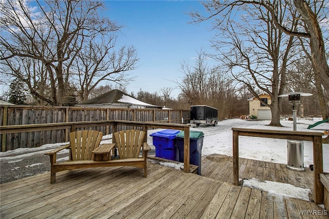 snow covered deck with fence