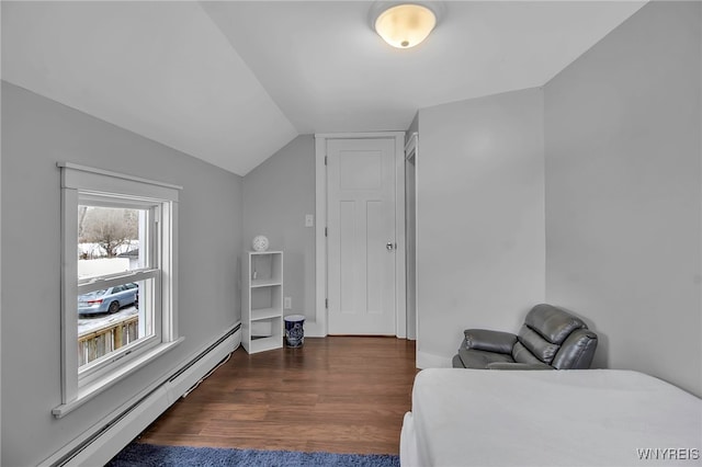 bedroom with a baseboard radiator, vaulted ceiling, and wood finished floors