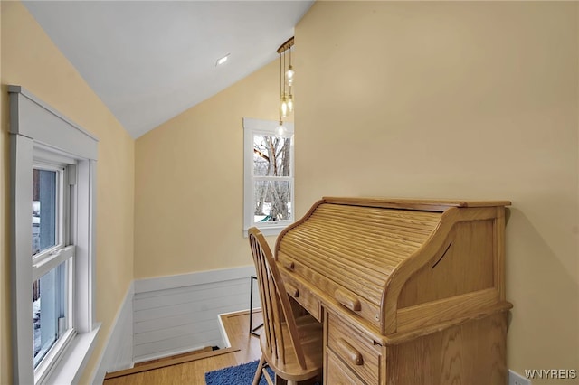 office space featuring vaulted ceiling and wood finished floors