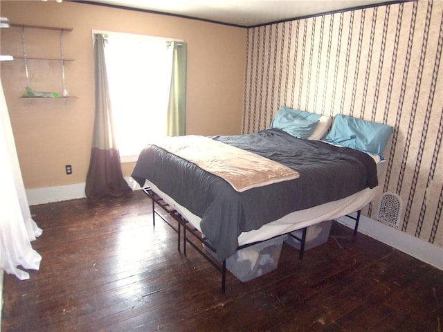 bedroom featuring wood-type flooring and baseboards