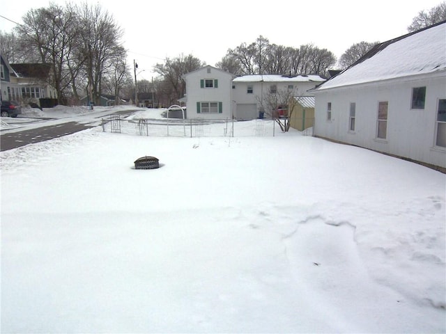 yard covered in snow with fence