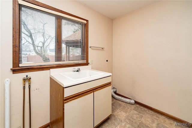 bathroom with vanity and baseboards