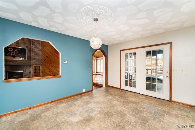 empty room with arched walkways and baseboards