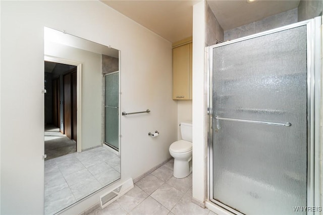 bathroom with visible vents, a shower stall, toilet, and tile patterned floors