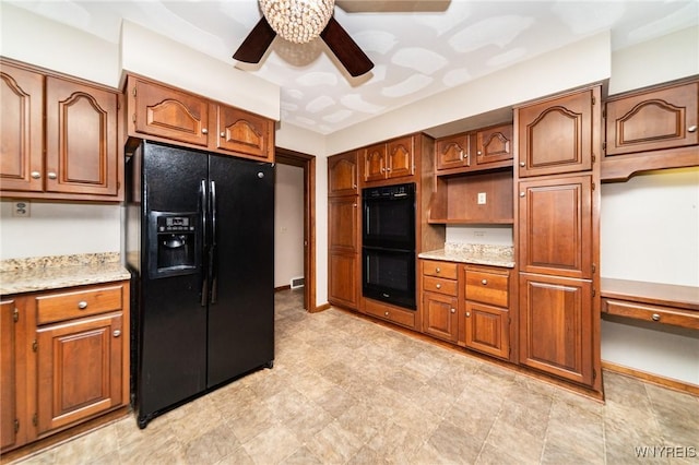 kitchen with black appliances, ceiling fan, baseboards, and brown cabinetry