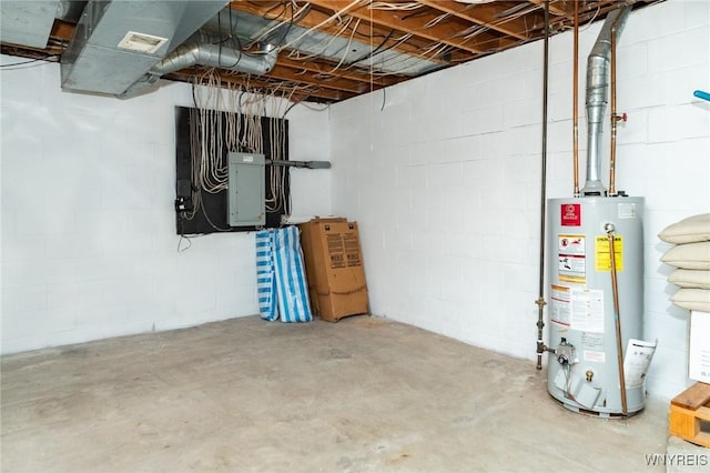 unfinished basement featuring concrete block wall, electric panel, and water heater