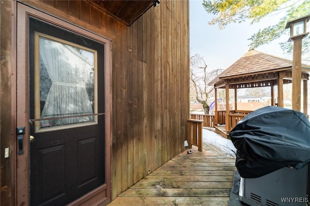 view of exterior entry featuring a wooden deck