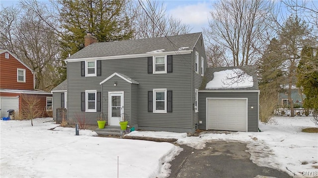 view of front of house featuring a garage and a chimney