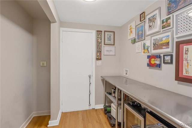 interior space with light wood finished floors and baseboards