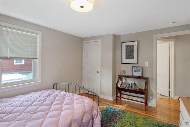 bedroom with wood finished floors and baseboards