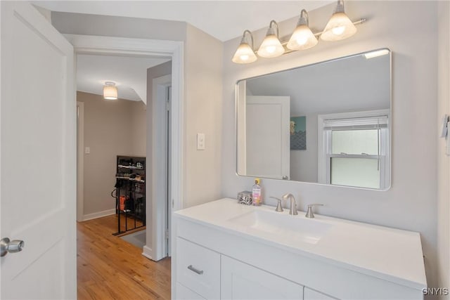 bathroom with wood finished floors and vanity