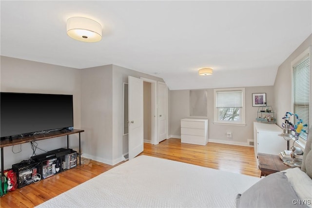 bedroom featuring wood finished floors and baseboards