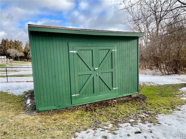 view of shed with fence