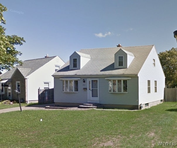 cape cod house featuring fence and a front lawn