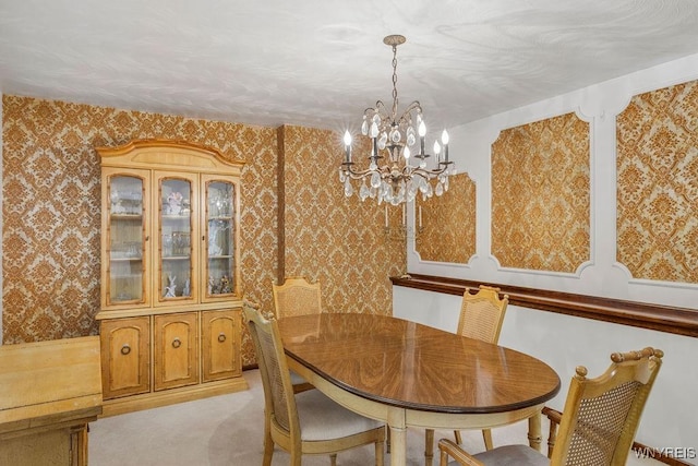 dining area featuring light carpet, wallpapered walls, and a chandelier