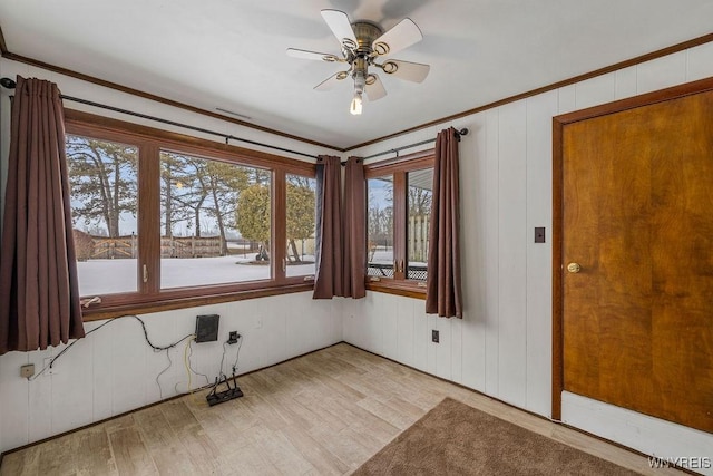 spare room featuring ceiling fan, wood finished floors, and crown molding