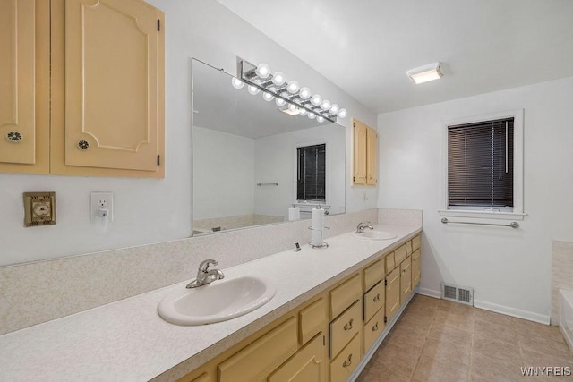 full bath featuring double vanity, tile patterned flooring, a sink, and visible vents