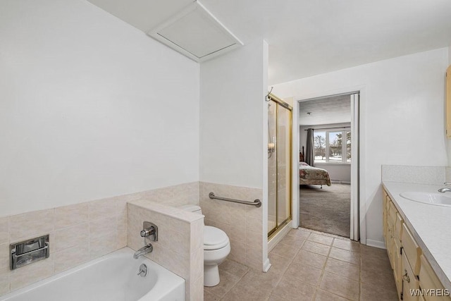 full bath featuring tile patterned flooring, toilet, vanity, a shower stall, and a bath