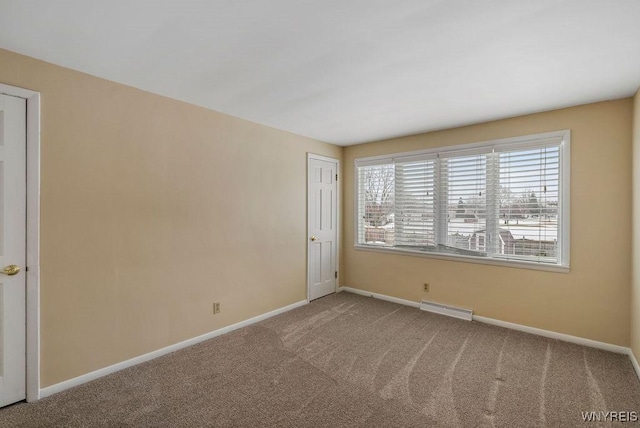 carpeted spare room with baseboards and visible vents