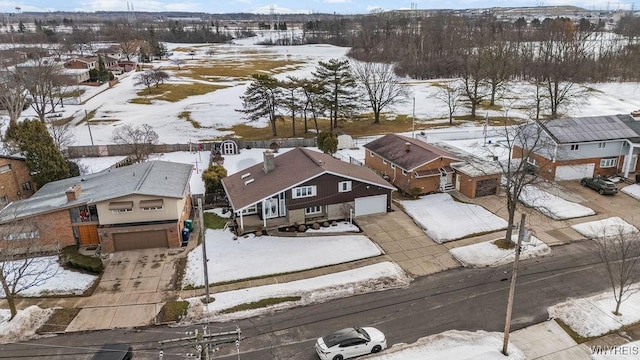 snowy aerial view with a residential view